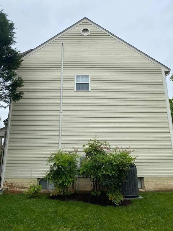 the back of a house with a window and a roof