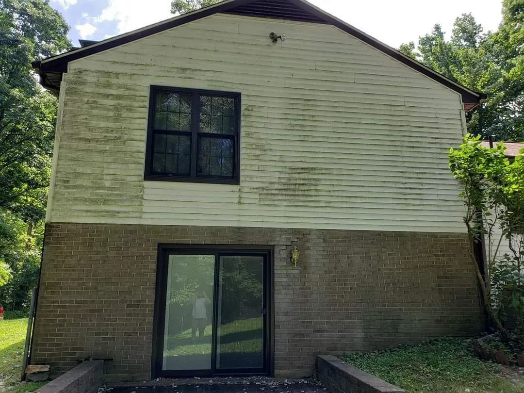 the back of a house with a sliding glass door and a window
