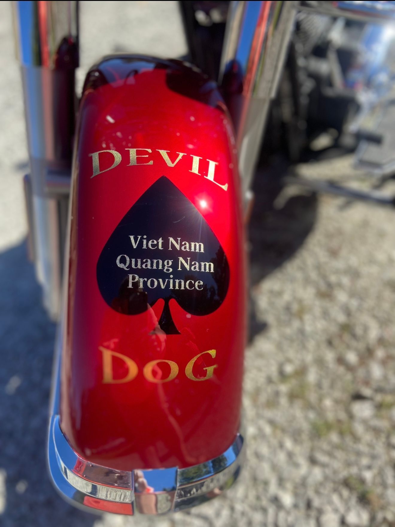 A red motorcycle with devil dog written on it