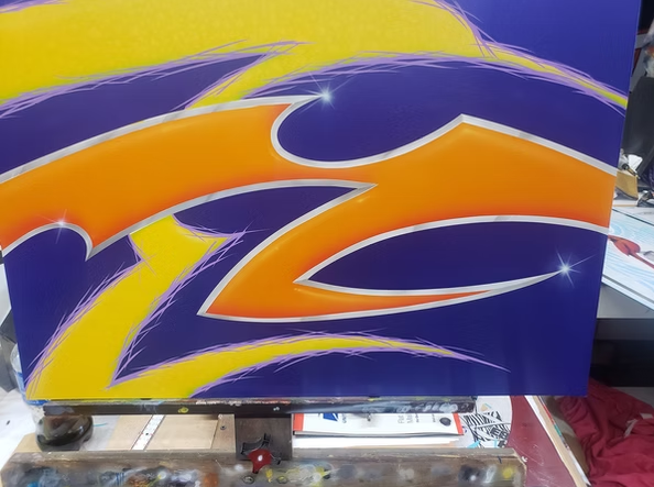 A purple and yellow painting with a flame on it