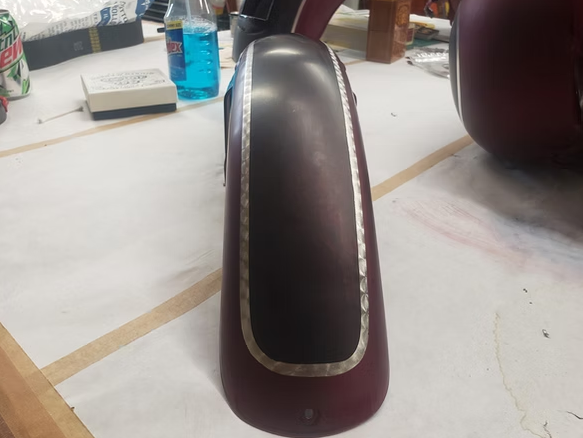 A close up of a motorcycle fender on a table