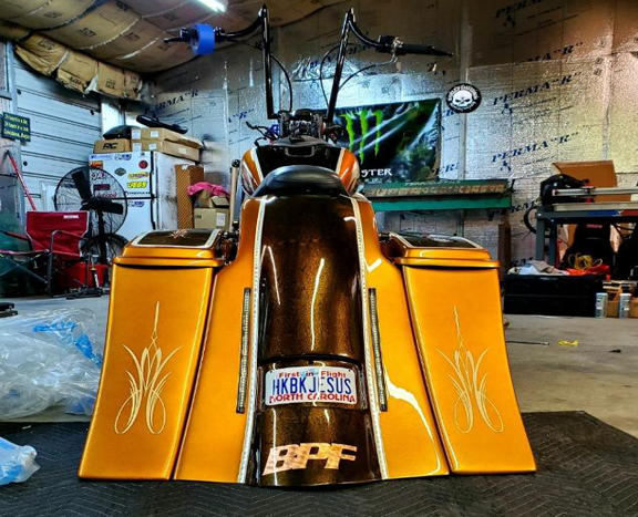 A motorcycle in a garage with a license plate that says bpf