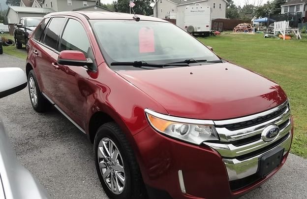 Red Ford SUV parked on a wet driveway in a suburban neighborhood