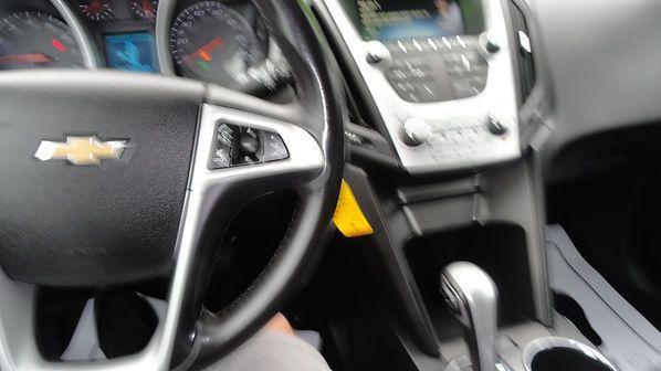 Chevrolet car interior with steering wheel, center console, and gear shift visible