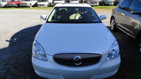 Front view of a white Volvo sedan parked in a lot