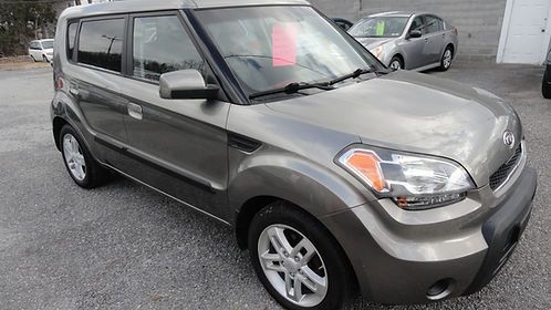 Gray compact SUV parked on a lot, angled front view with a red tag in the windshield.