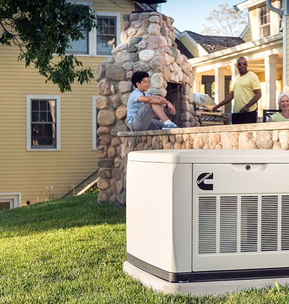 A home generator in a backyard setting with family members gathered near a fireplace.
