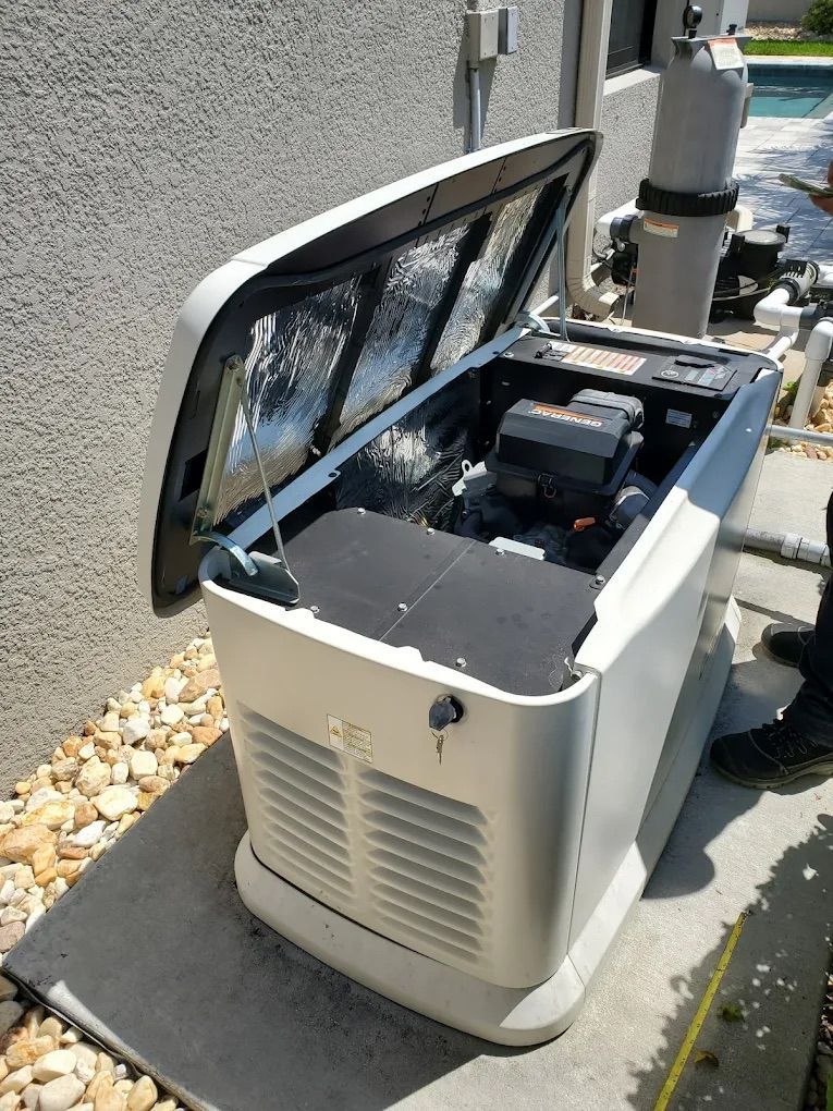 Generator with open lid, revealing engine. Outdoors, next to a pool.