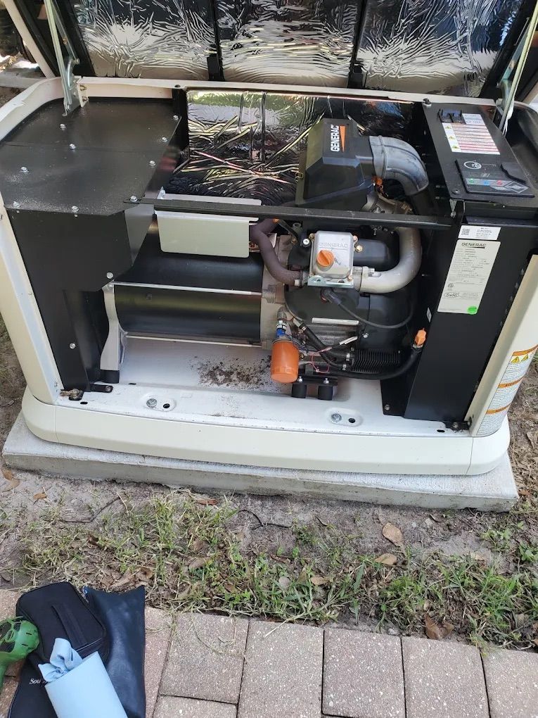 A residential generator with open panels, showing its internal components.