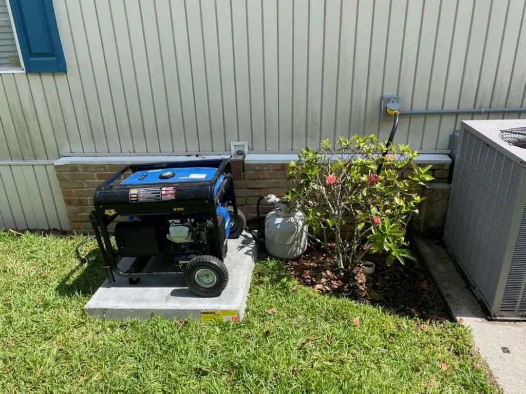 A portable generator on a concrete pad next to a house with a propane tank and air conditioning unit.