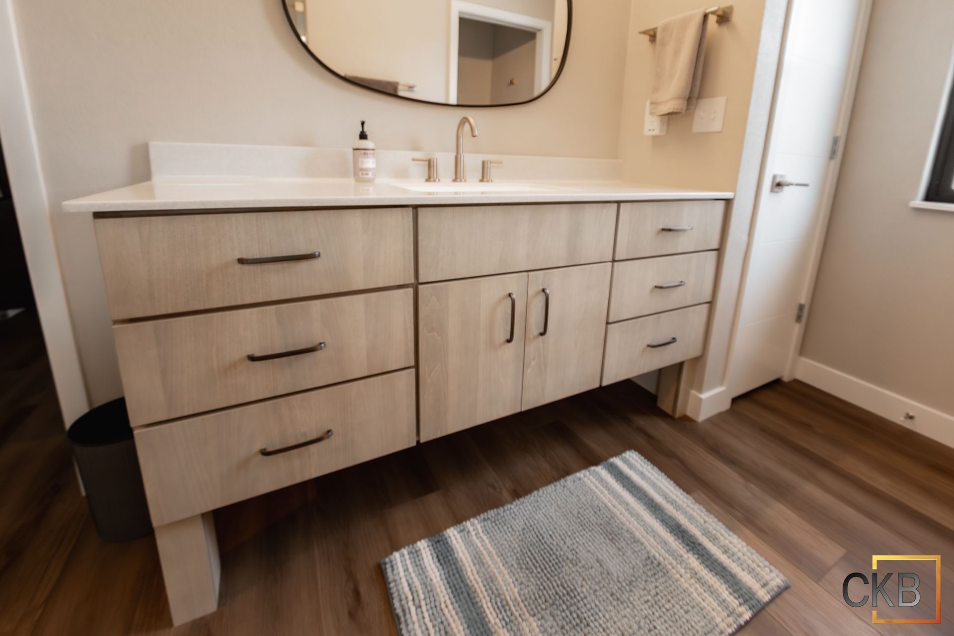 A bathroom with a sink , dresser , and mirror.
