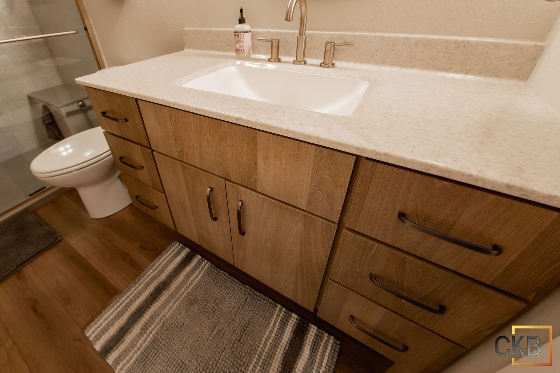 A bathroom with a sink , toilet and shower.