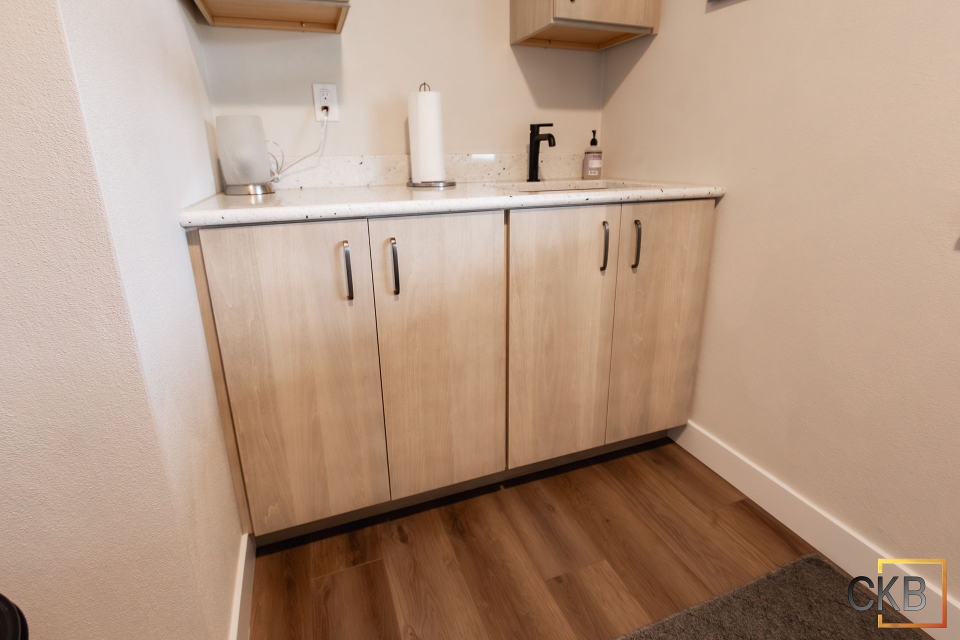A small kitchen with wooden cabinets and a sink.