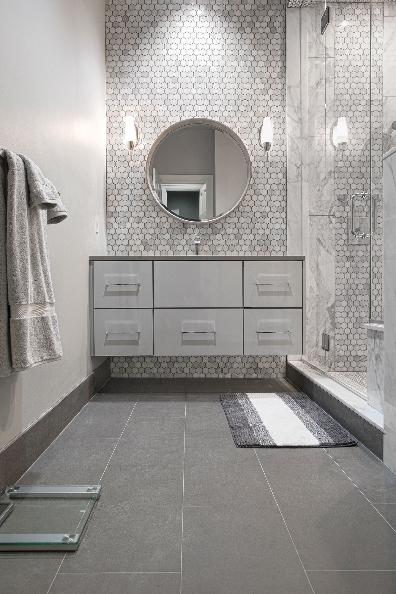 A bathroom with a sink , mirror , and shower.