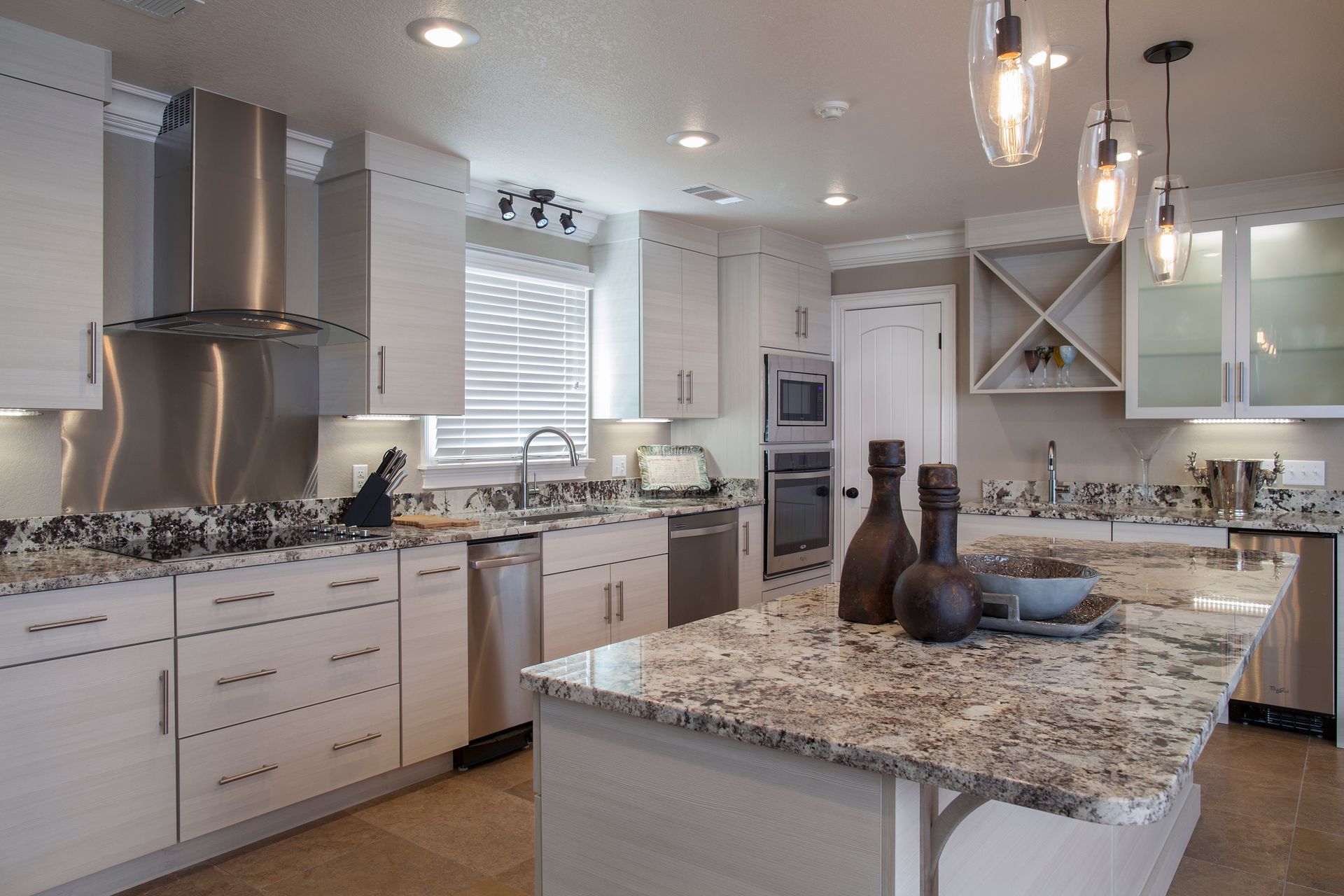 A kitchen with granite counter tops and stainless steel appliances