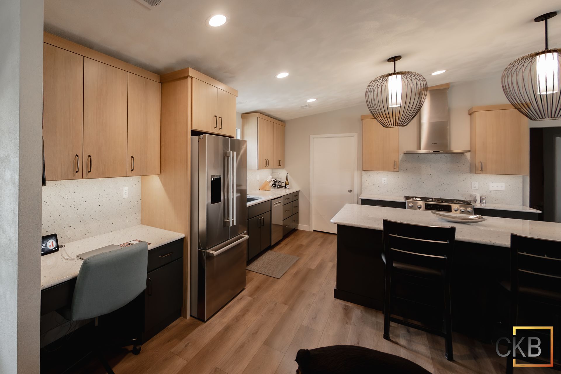 A kitchen with stainless steel appliances and wooden cabinets