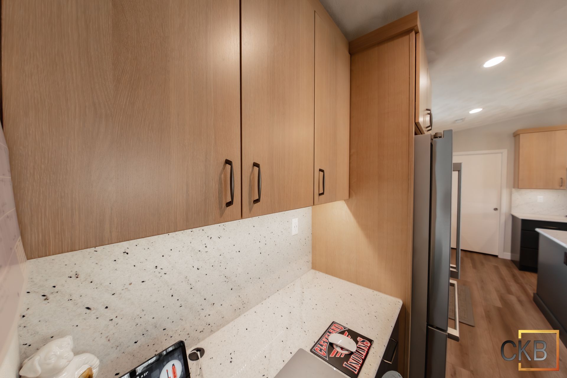 A kitchen with wooden cabinets and white counter tops