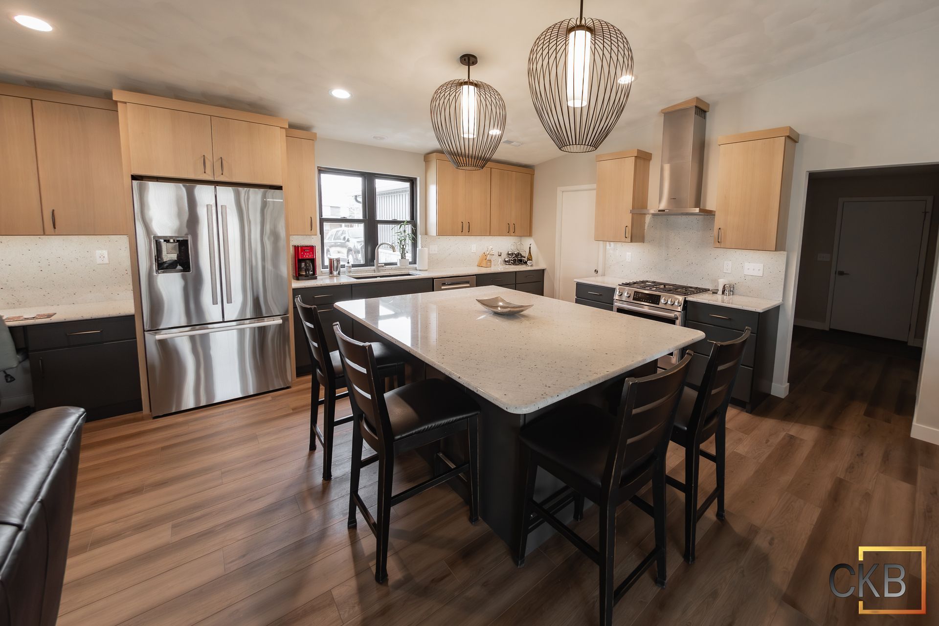 A kitchen with a large island and stainless steel appliances