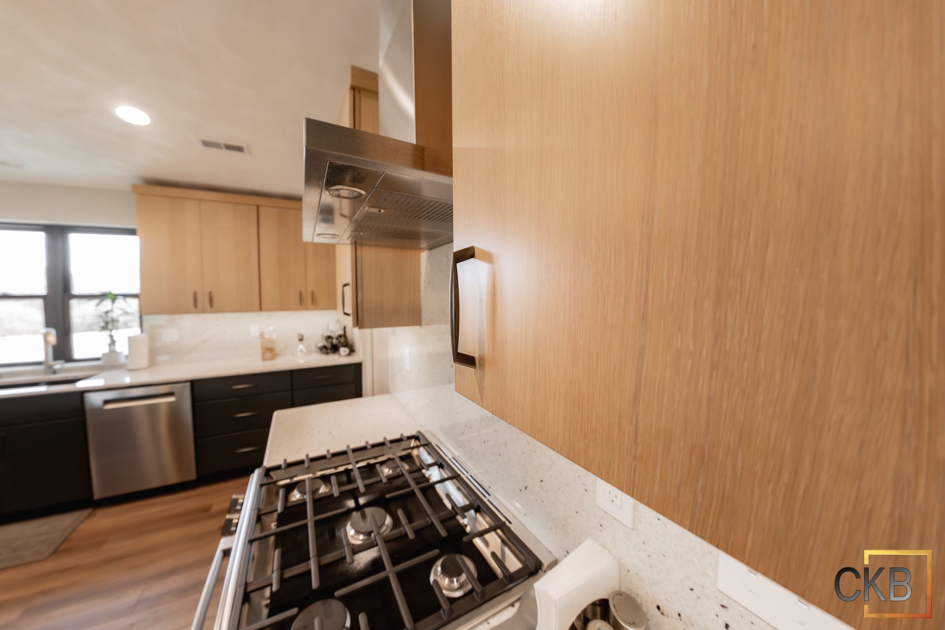 A kitchen with stainless steel appliances and wooden cabinets.