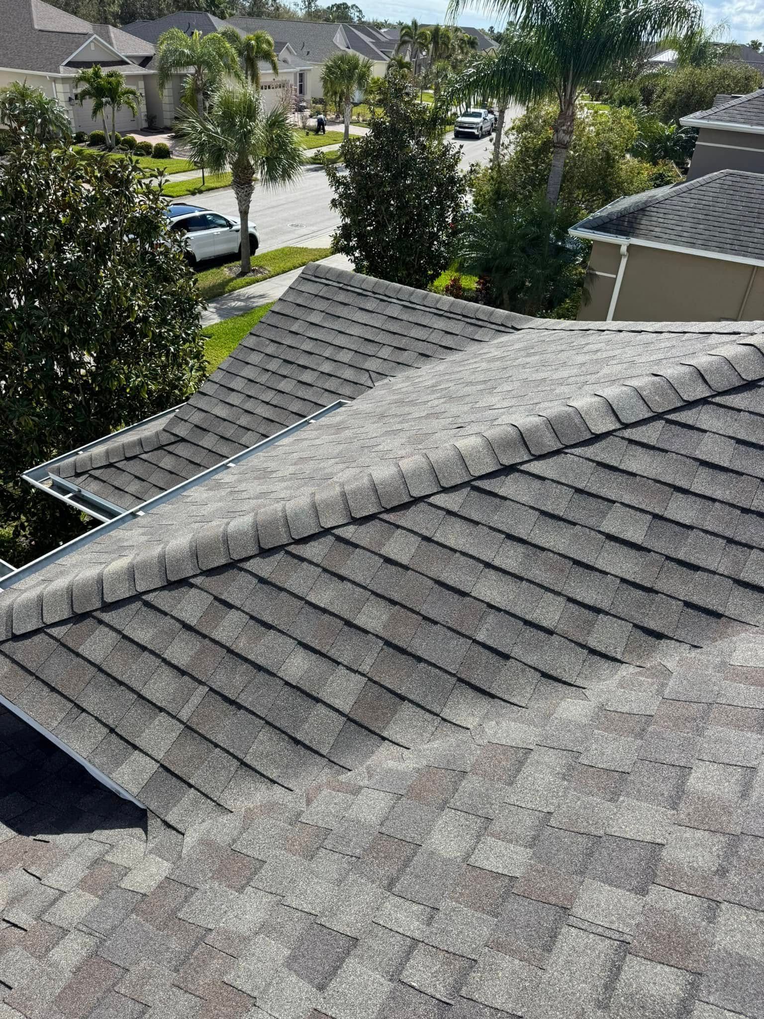 An aerial view of a roof of a house in a residential area.
