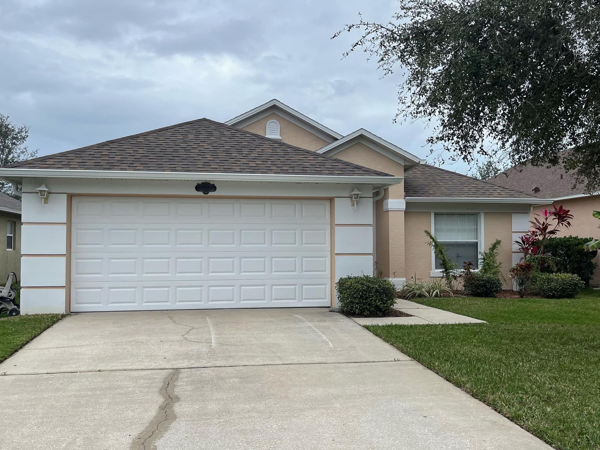 A house with a white garage door and a driveway