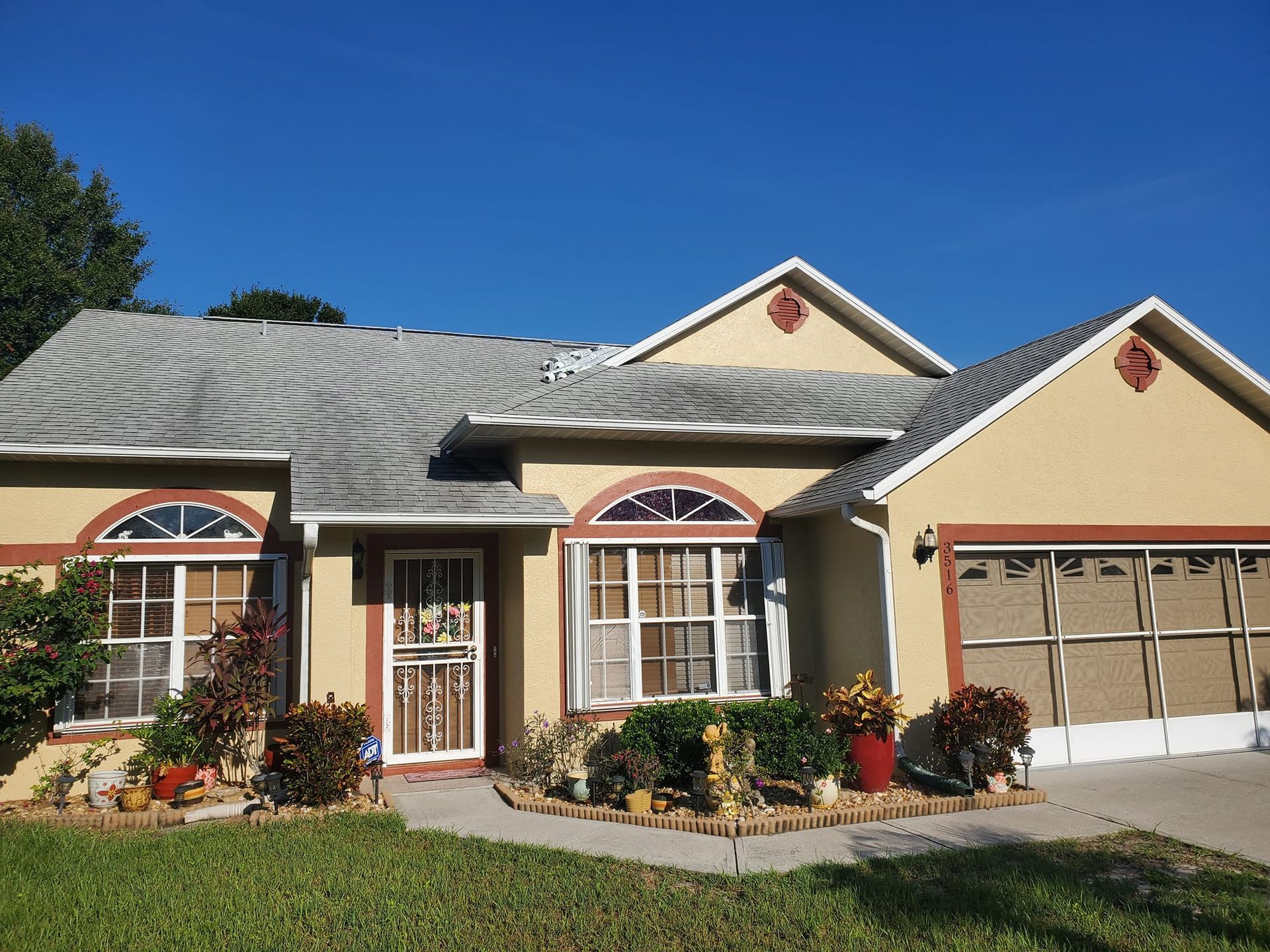 A house with a lot of windows and a gray roof