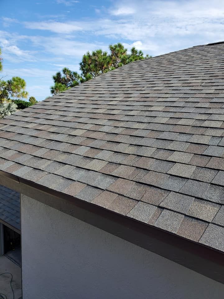 A close up of a roof with shingles on a house.