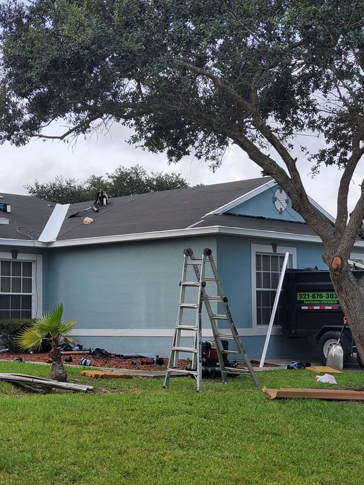 A blue house with a black van parked in front of it.