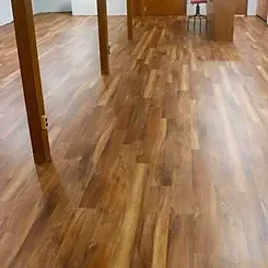 A wooden floor in a kitchen with a table and chairs.