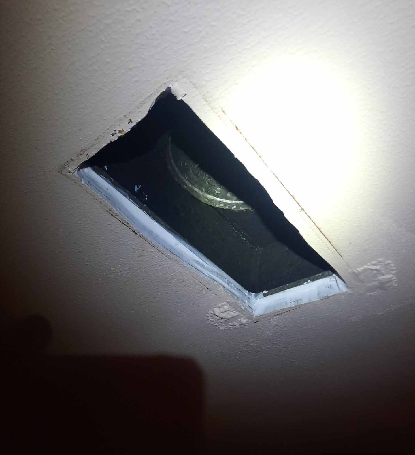 A light is shining through a hole in the ceiling
