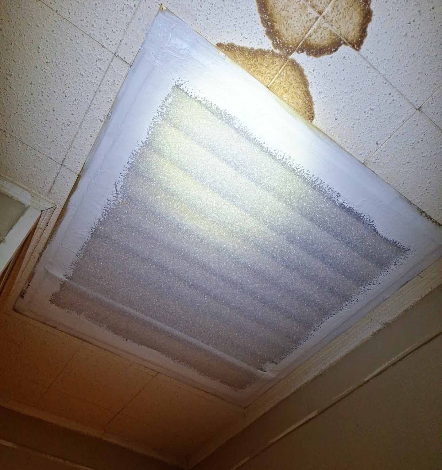 A ceiling vent with a light shining through it