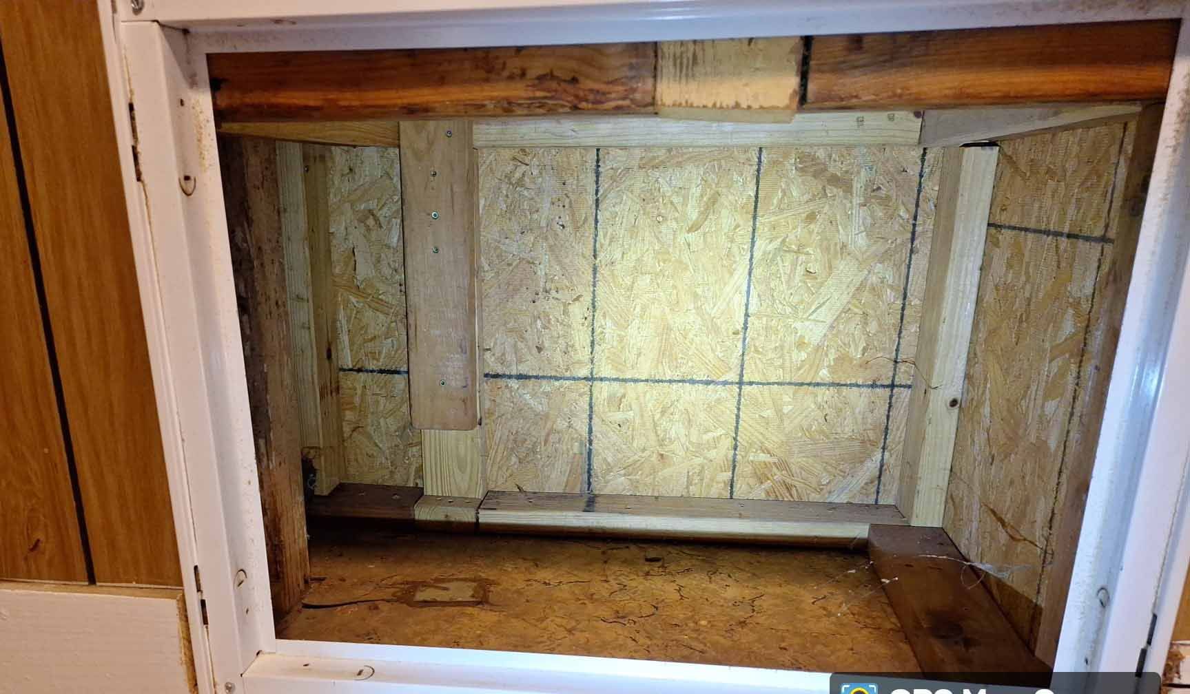 A room with a window and a shelf in it
