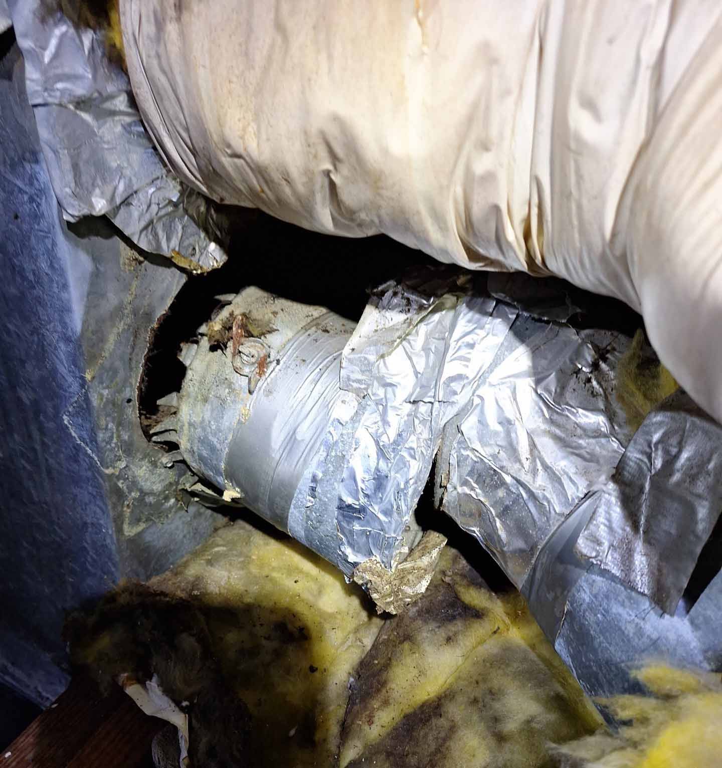 A person is holding a piece of aluminum foil in their hand.
