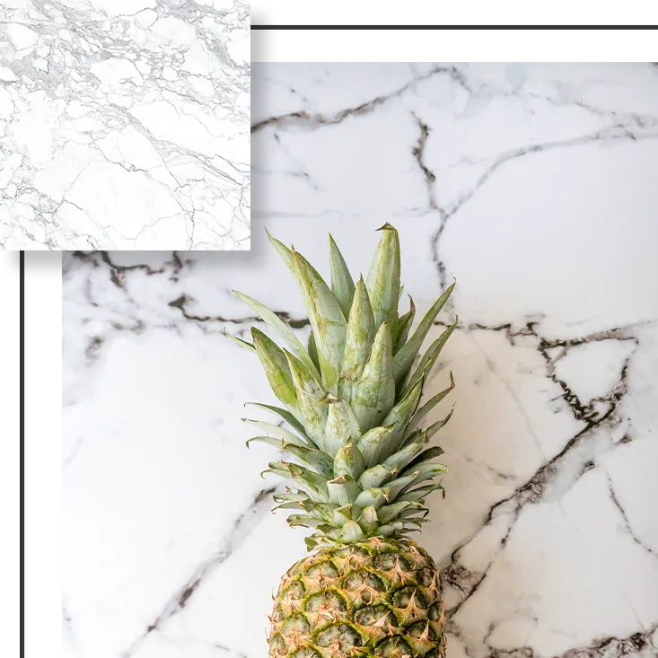 Pineapple on marble surface, with square marble sample in corner.