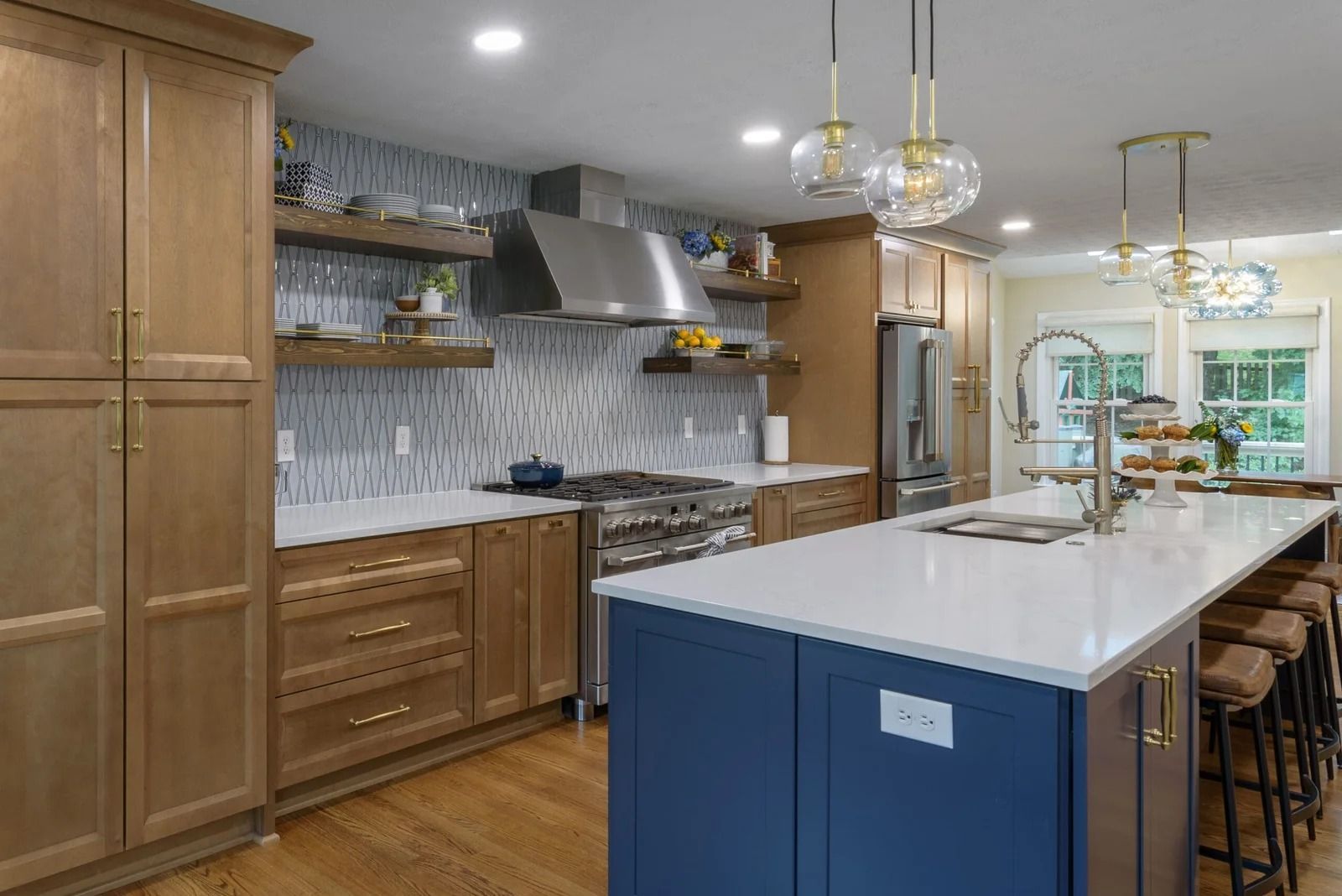 Modern kitchen with blue island, wooden cabinets, and white countertops.
