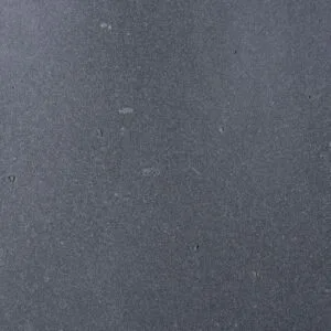 Gray-blue, textured stone surface with small light-colored speckles.