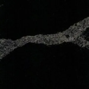 Black countertop with a jagged, light gray vein running through it.