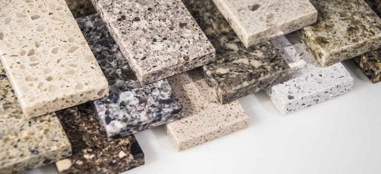 Various samples of stone countertops in different colors and textures.
