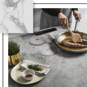 Person cooking fish on a marble-style countertop. Includes a plate with herbs, a pot, and a cooking utensil.