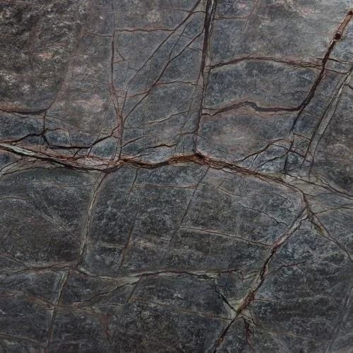 Dark gray stone surface with brown veins and cracks.