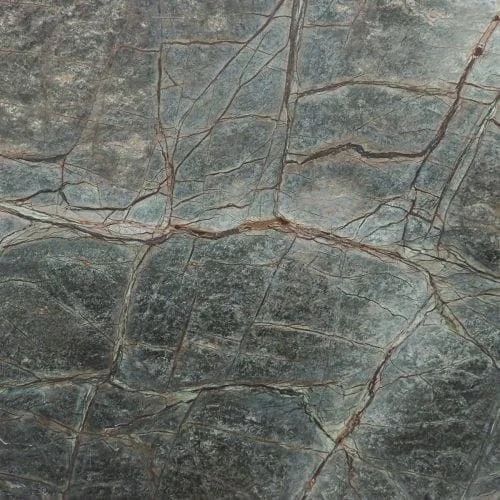 Gray-green stone surface with dark veining and cracks.