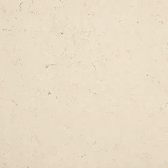 Cream-colored wall texture with subtle variations and dark flecks throughout.