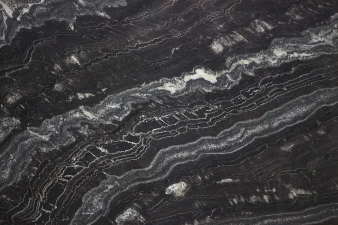 Black and white marbled stone with swirling, layered patterns.