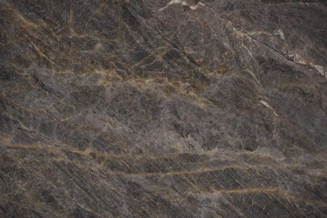 Close-up of a dark brown and gray marble slab with light tan veining.