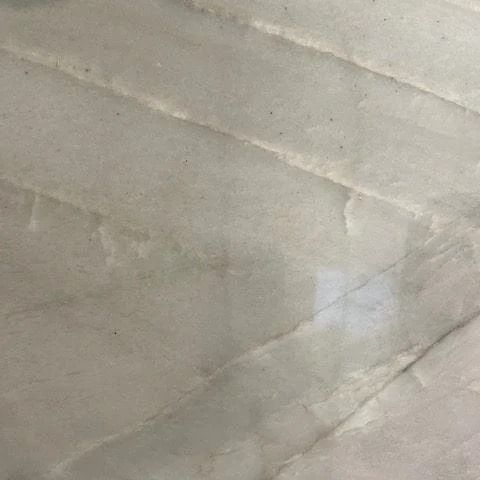 Light, textured surface with diagonal stitched pattern.