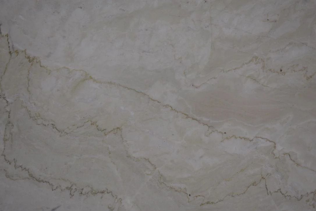 Beige marble with swirling patterns and brown veins.
