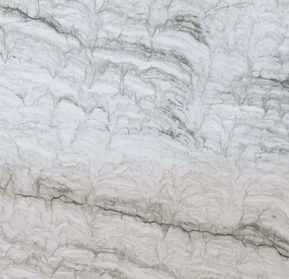 White marble with gray veining and crack running across the surface.