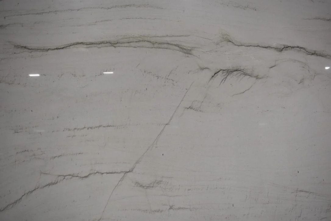 White and gray marble surface with veining patterns.