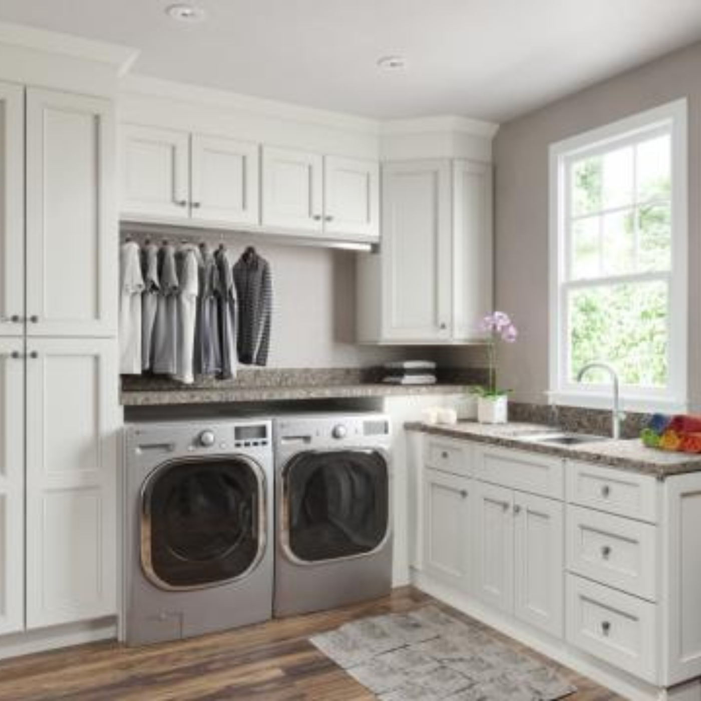 A laundry room with a washer and dryer and a window.