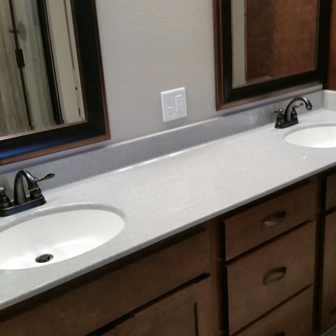 A bathroom with two sinks and two mirrors